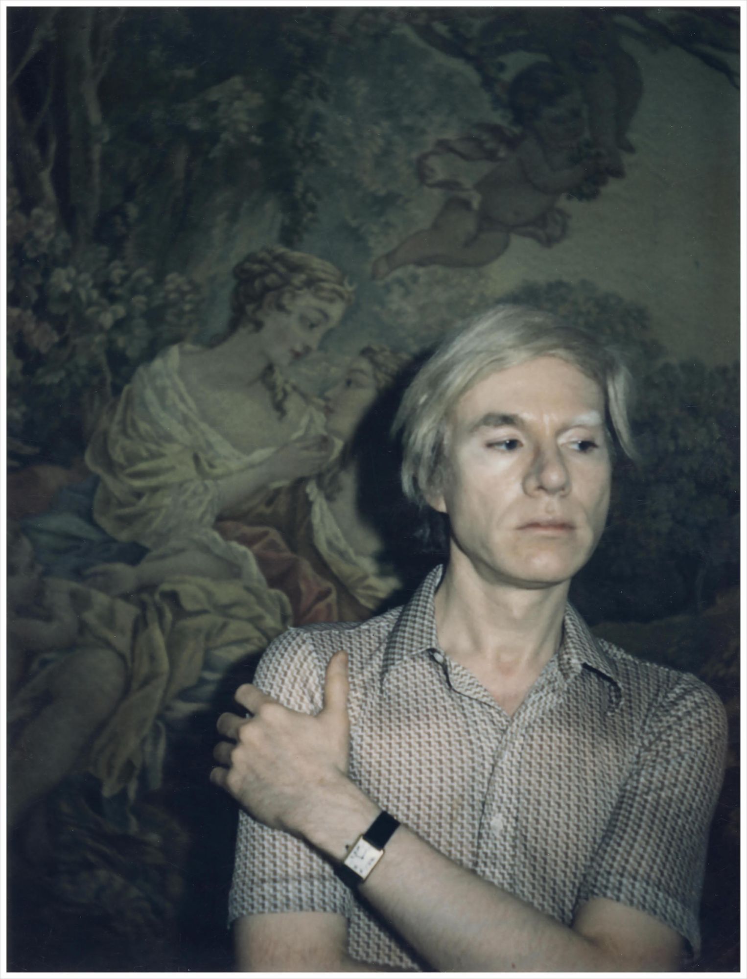 Andy Warhol wears a Cartier Tank watch in a self-portrait polaroid