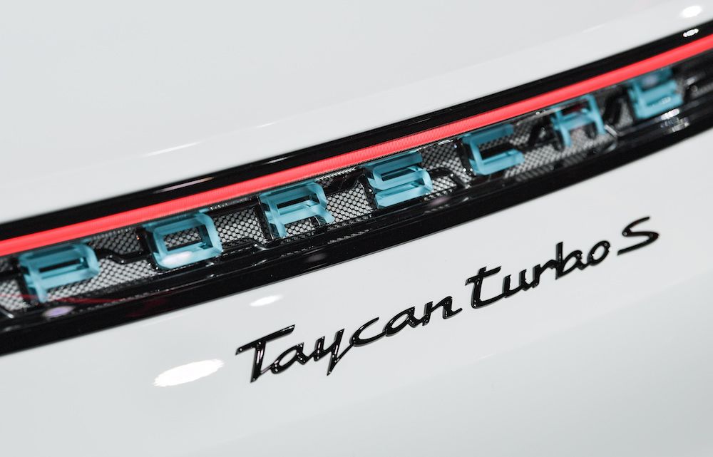The logo of a Porsche Taycan turbos S electric car as seen during its presentation as world premiere on August 4, 2019 in a hall of the airfield of Neuhardenberg, north-east of Berlin. - The first pure electric model is presented at the same time on three continents and will be delivered starting the new year, with the USA ahead. (Photo by Patrick Pleul / dpa / AFP) / Germany OUT (Photo credit should read PATRICK PLEUL/AFP/Getty Images)