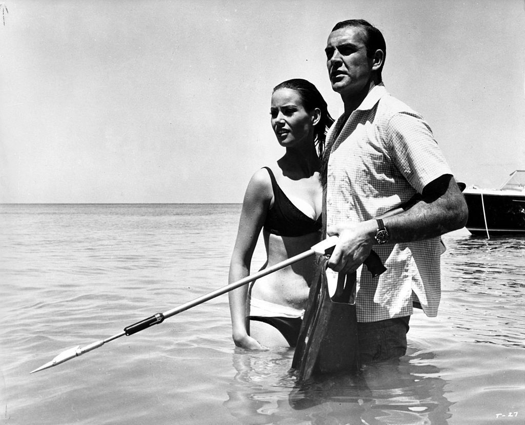 Sean Connery as James Bond protects Claudine Auger as Domino in a scene from the movie "Thunderball", circa 1965. (Photo by Michael Ochs Archives/Getty Images)