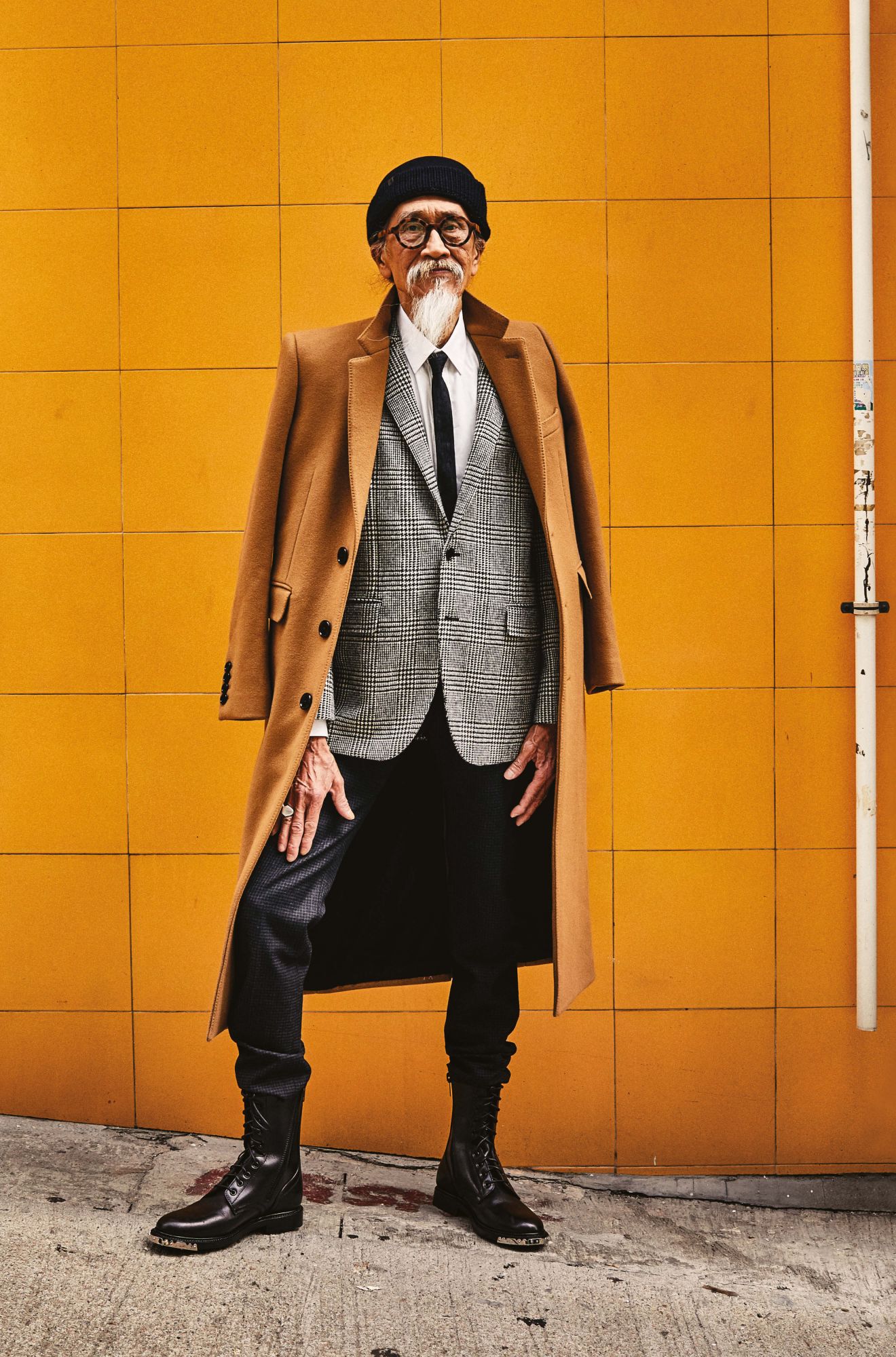 Coat, jacket, shirt, trousers, shoes, tie and ring by Celine; beanie by Emporio Armani; glasses by Prada