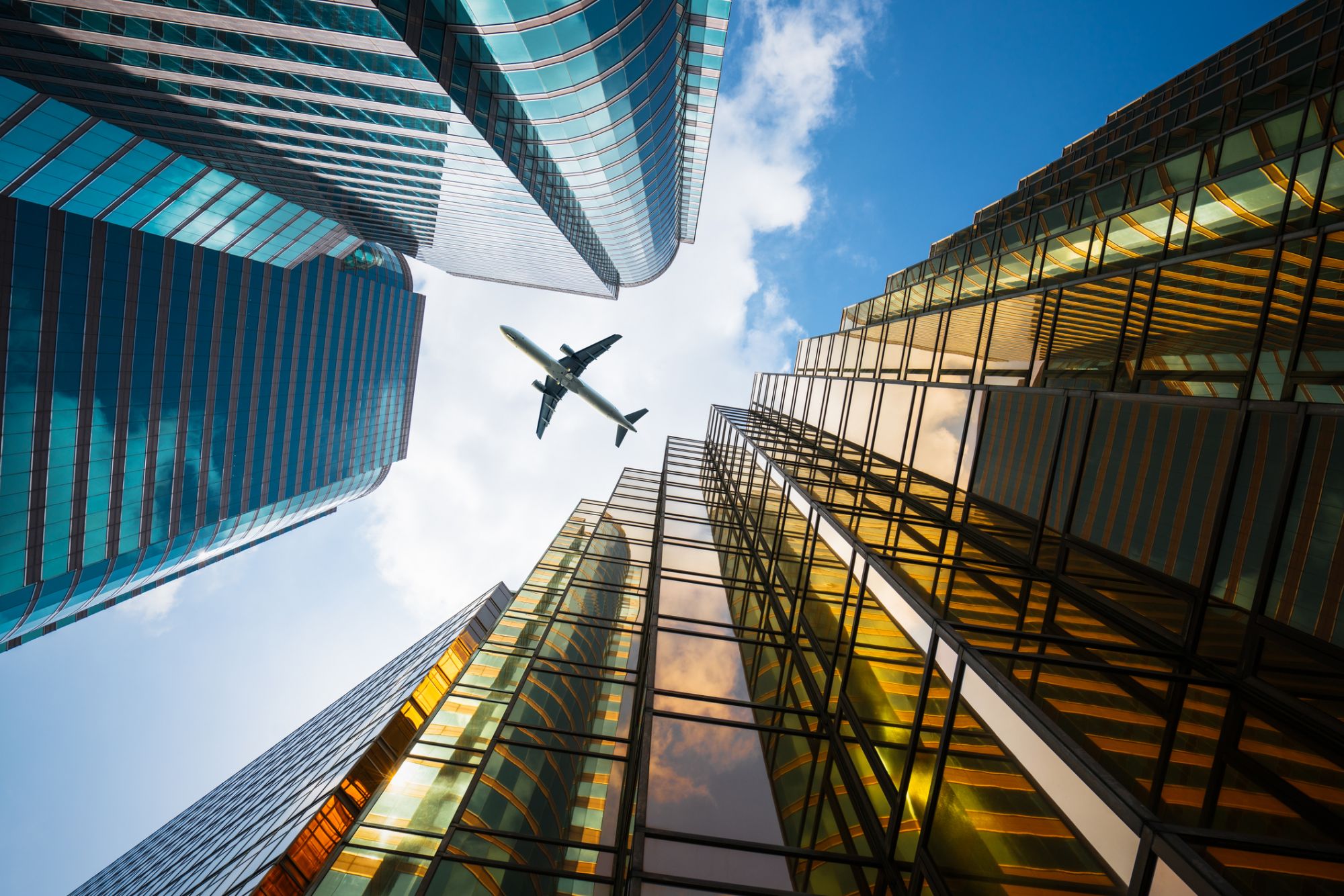 directly below of skyscrapers with flying airplane,Hong Kong,China,East Asia.