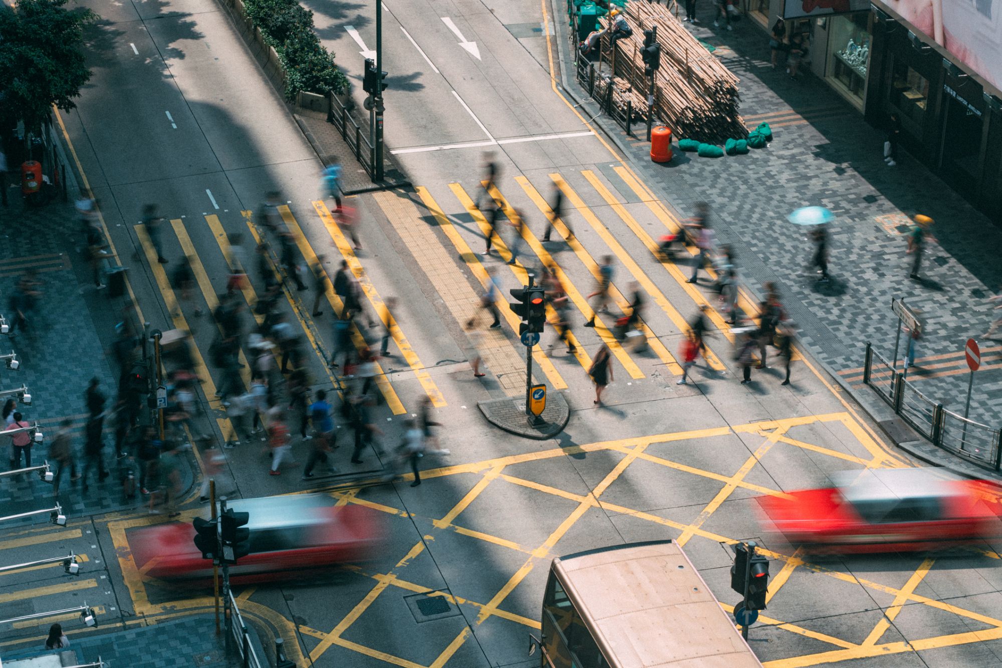 People and taxi cabs crossing a very busy crossroads in Tsim Sha Tsui district Hong Kong, China