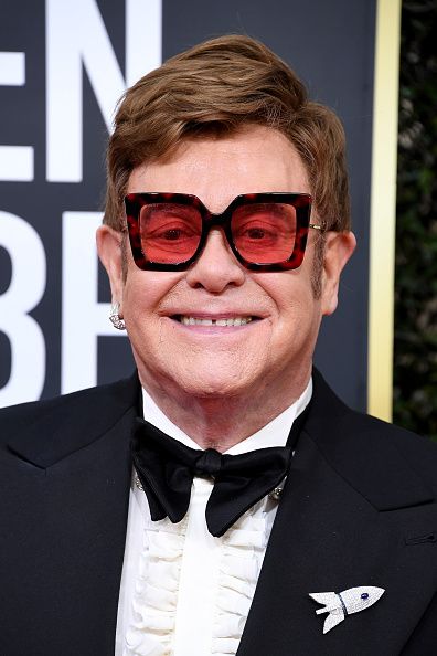 Sir Elton John wore a bespoke 18-karat gold Rocket Man-inspired brooch set with diamonds, designed by the British jeweller Theo Fennell