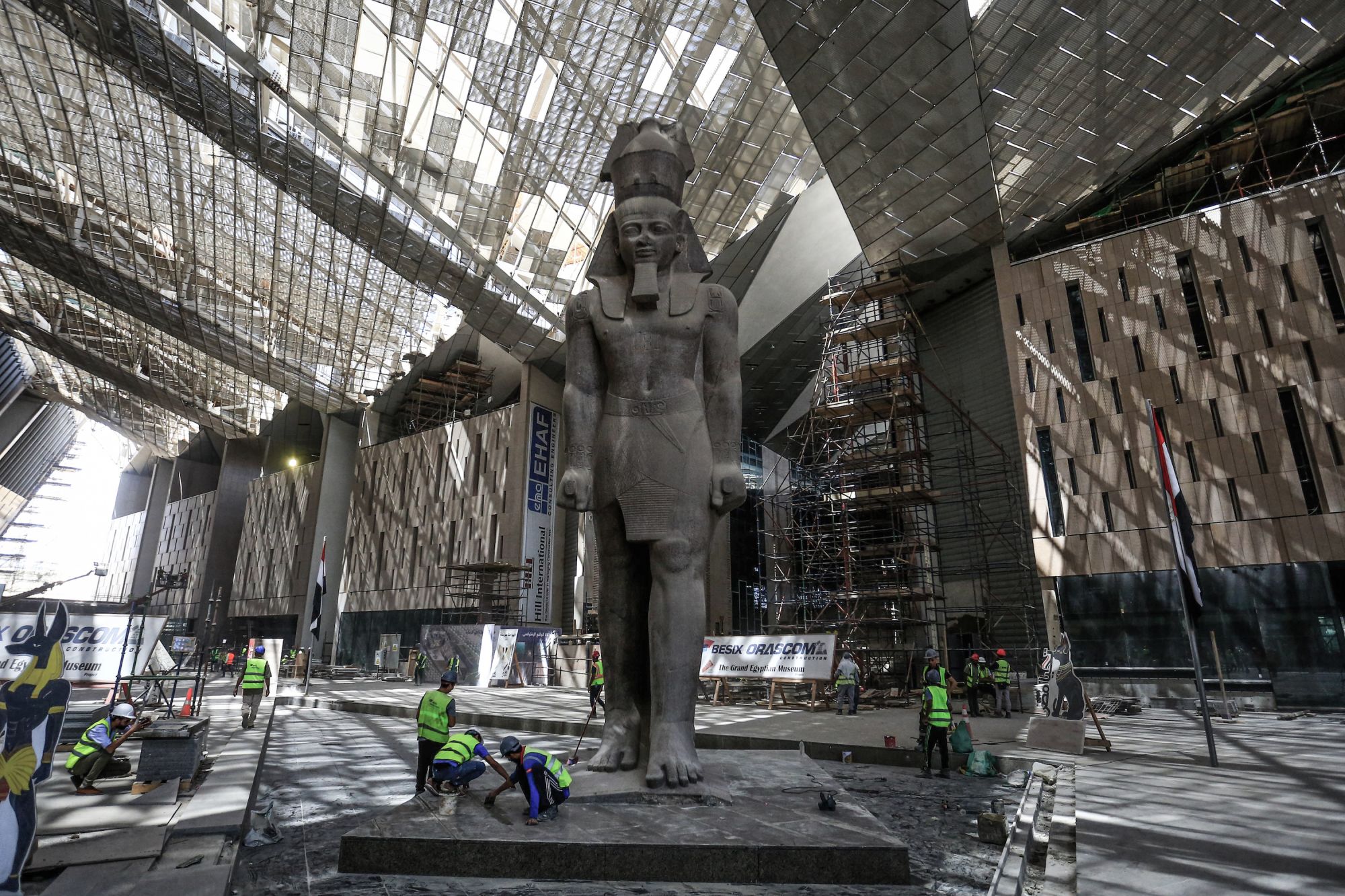 04 August 2019, Egypt, Giza: Workers clean the area next to a giant statue of the Egyptian pharaoh Ramses II in hall of the Grand Egyptian Museum in Giza outside Cairo. Photo: Hassan Mohamed/dpa (Photo by Hassan Mohamed/picture alliance via Getty Images)