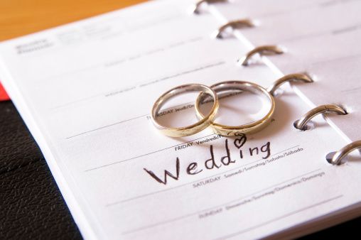 "rings on a weekly planner calendar. Ad your own date, friday is marked with wedding."