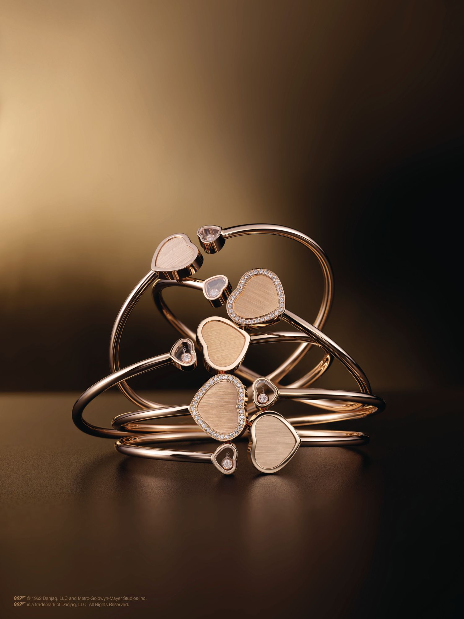 Bangles in rose gold set with diamonds, all from the Happy Hearts—Golden Hearts collection by Chopard