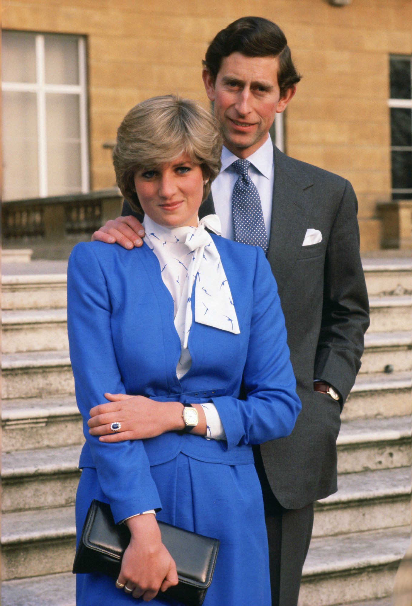 GREAT BRITAIN - FEBRUARY 24: Lady Diana Spencer (later to become Princess of Wales) reveals her sapphire and diamond engagement ring while she and Prince Charles, Prince of Wales pose for photographs in the grounds of Buckingham Palace following the announcement of their engagement (Photo by Tim Graham Photo Library via Getty Images)