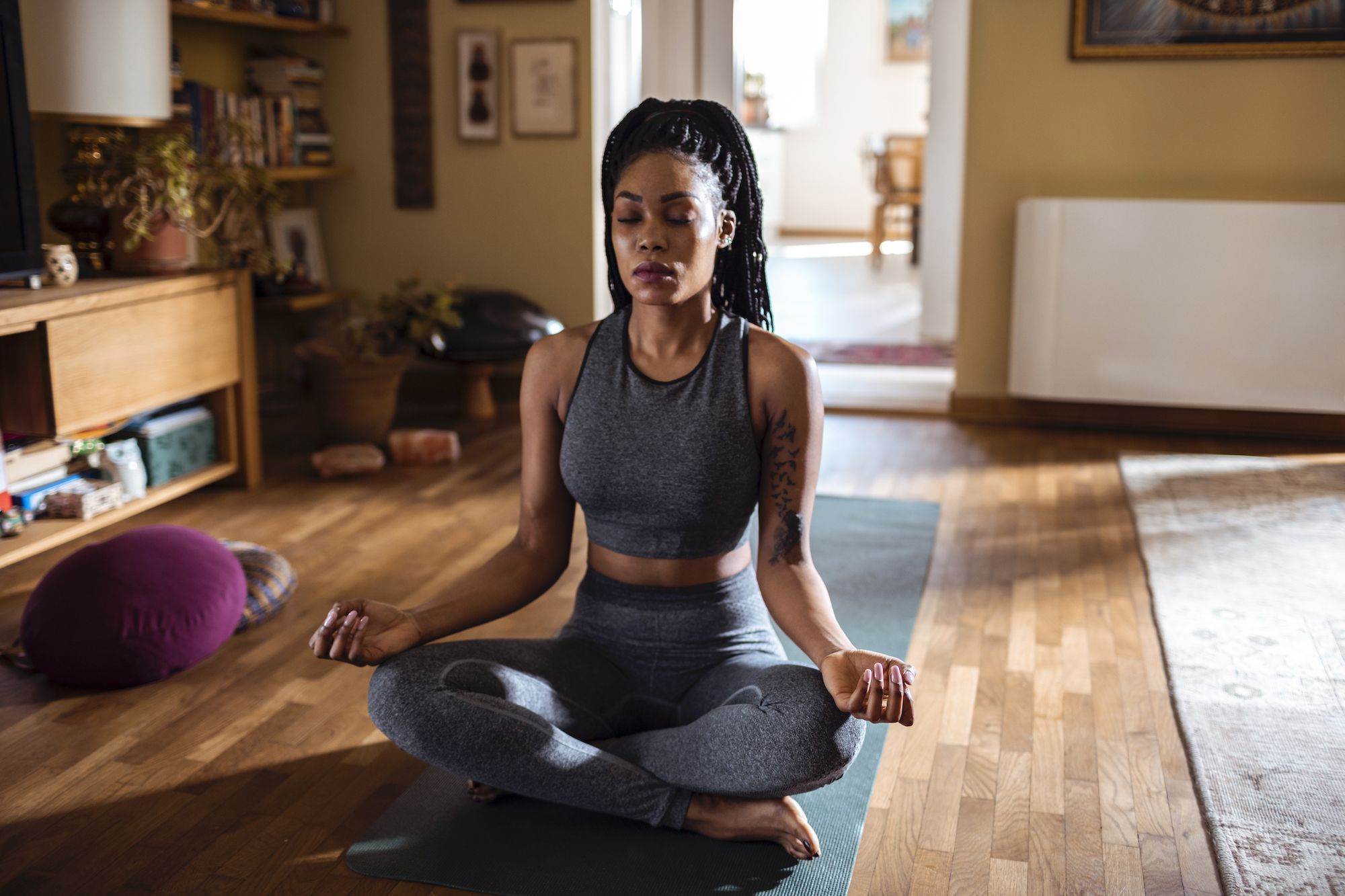 Close up of a young woman meditating at home