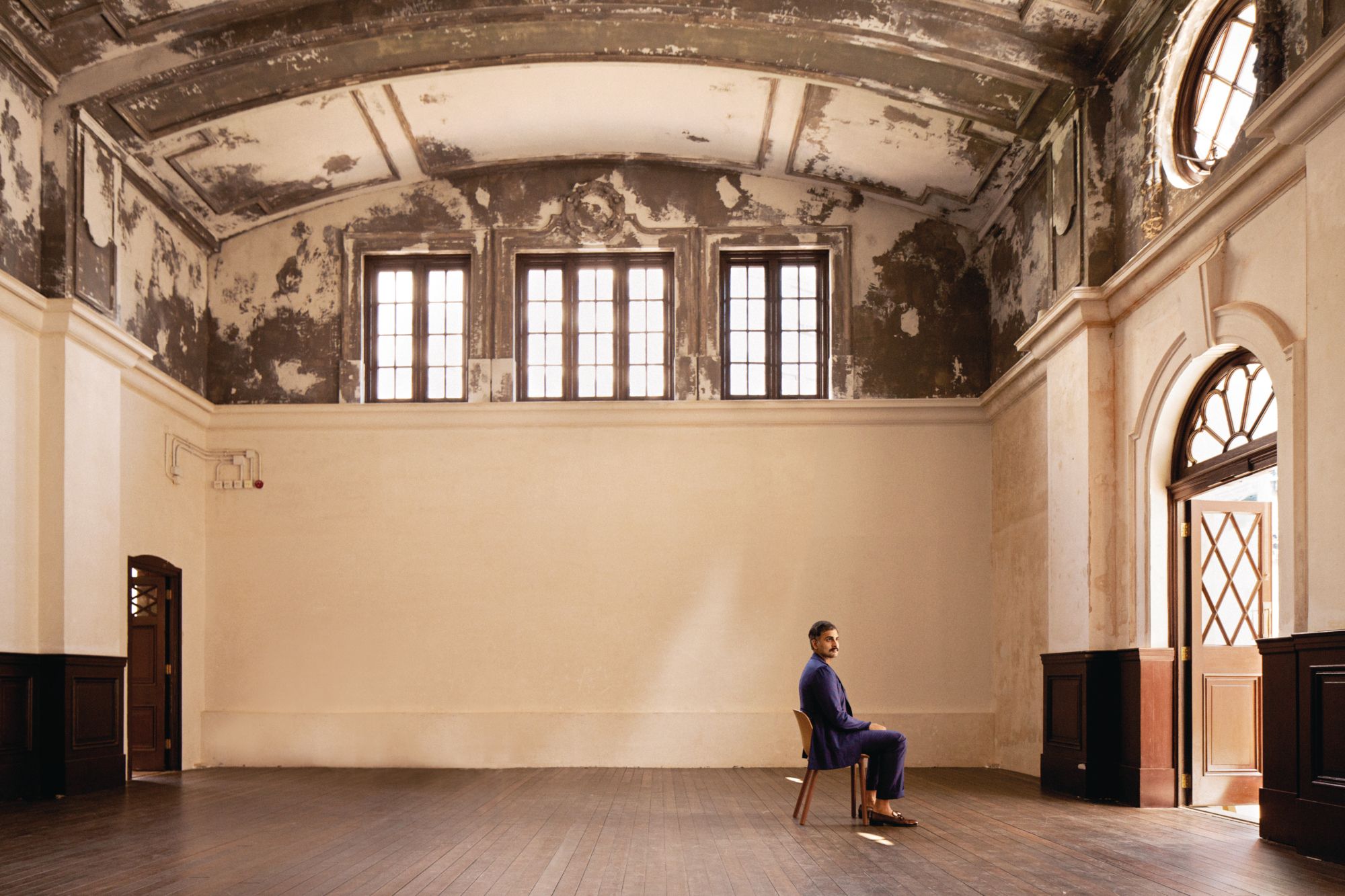 Syed Asim Hussain sitting in Tai Kwun, Hong Kong