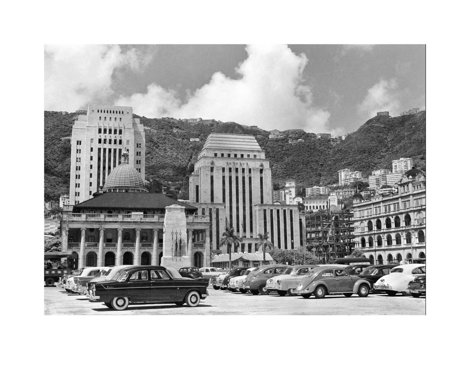 Vehicles on the Central Reclamation, with the Chartered Bank (right background) seen under redevelopment, Hong Kong in the 1950s. (Photo: Lee Fook Chee, © The Estate of Lee Fook Chee. Courtesy of Sino Group)
