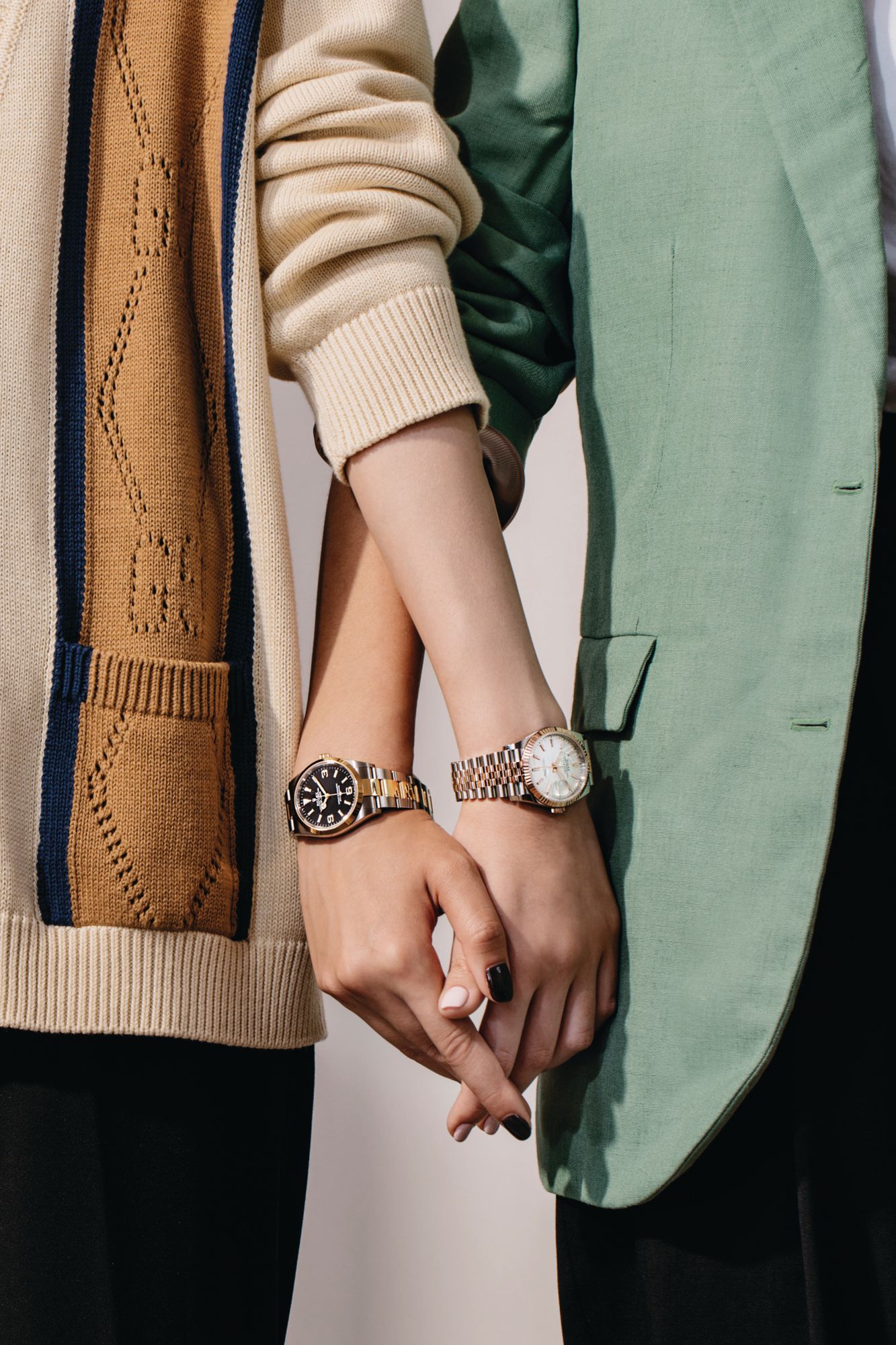 Oyster in Perpetual Datejust 36 in Oystersteel and Everose Gold, Oyster Perpetual Explorer in Oystersteel and yellow gold, both by Rolex. Gucci cardigan and blazer, Versace trousers