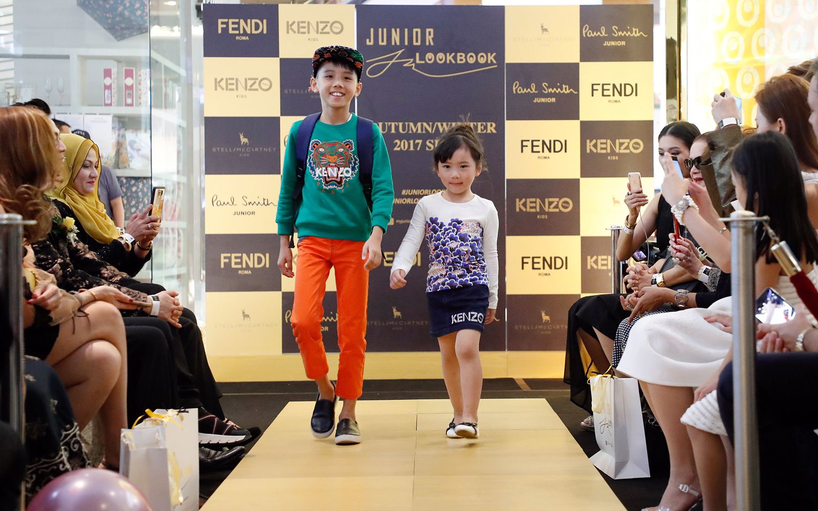 Roger Shak Yi and Wong Yi Kei wearing Kenzo Kids