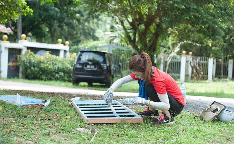 Yen Goh painting one of the window frames.