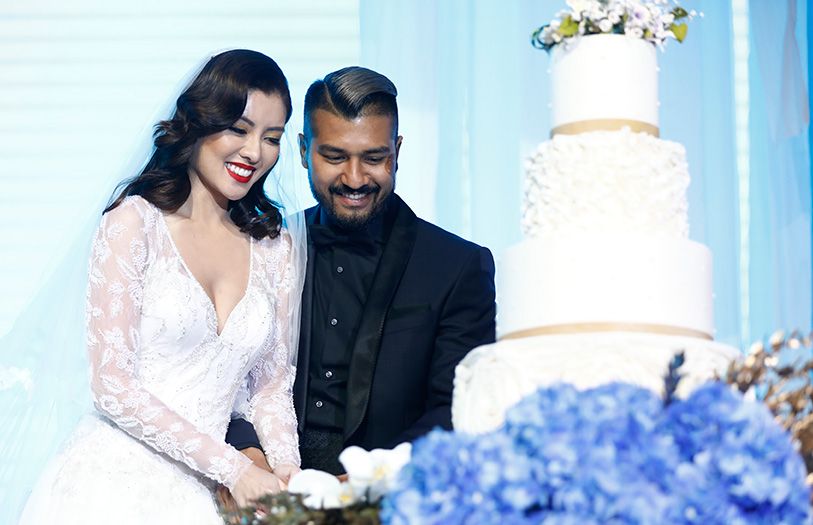 The newlyweds cutting their wedding cake