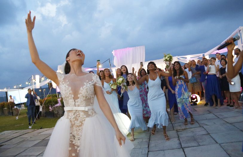 The bride throwing the bouquet for her bridesmaids