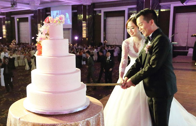 Pei Lu Lim and Ong Jian Win cutting their wedding cake