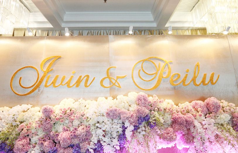 The cocktail area featured an elaborate photo wall decorated with lush blooms and the couple’s names in elegant cursive letters.