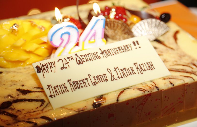 The couple, along with daughters Amira and Aishah were invited up front to cut a special anniversary cake.