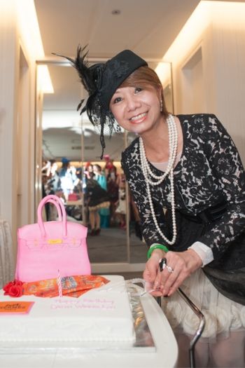 The founder of the 'A Cut Above' chain of hairdressing salons, together with close friends, dressed up in elaborate hats and hair pieces to commemorate her special day.