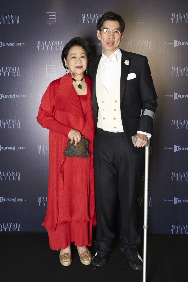 Catherine Mah in Issey Miyake and Gabriel Mah in Saville Row