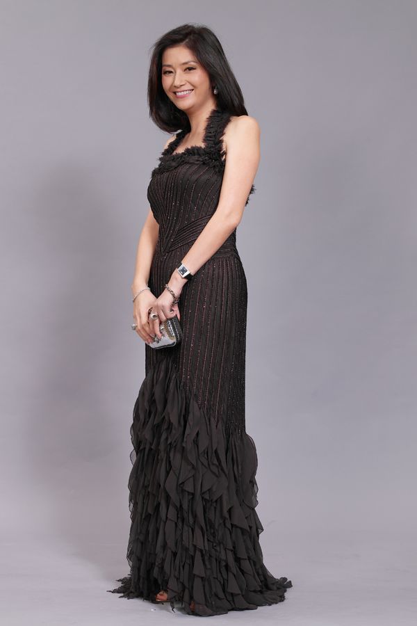 Datin Rita Shum wearing a black dress with symmetrical patterns (2008)