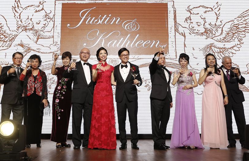 Justin Law and Kathleen Wong toasting to the beginning of their happily ever after