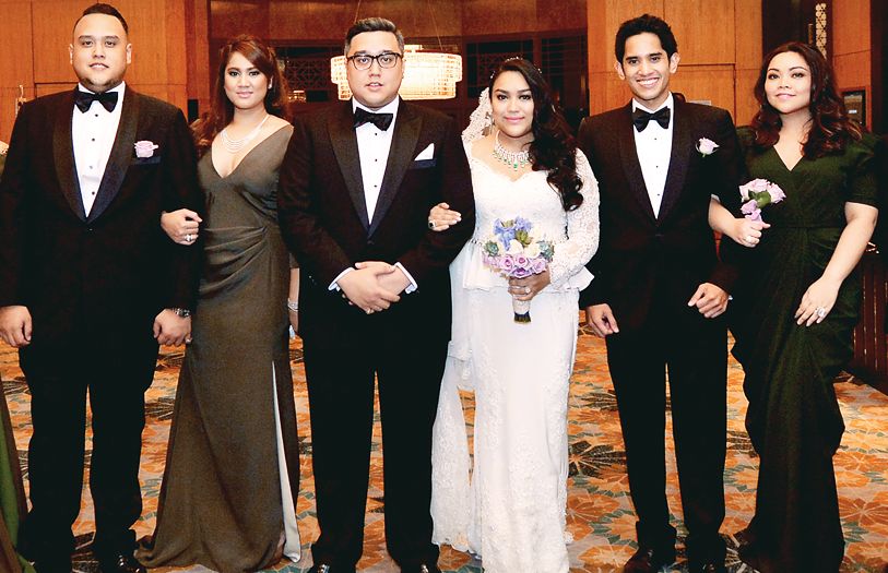 Ikhwan Nafik and Kerina Shah (both middle) with their bridal entourage