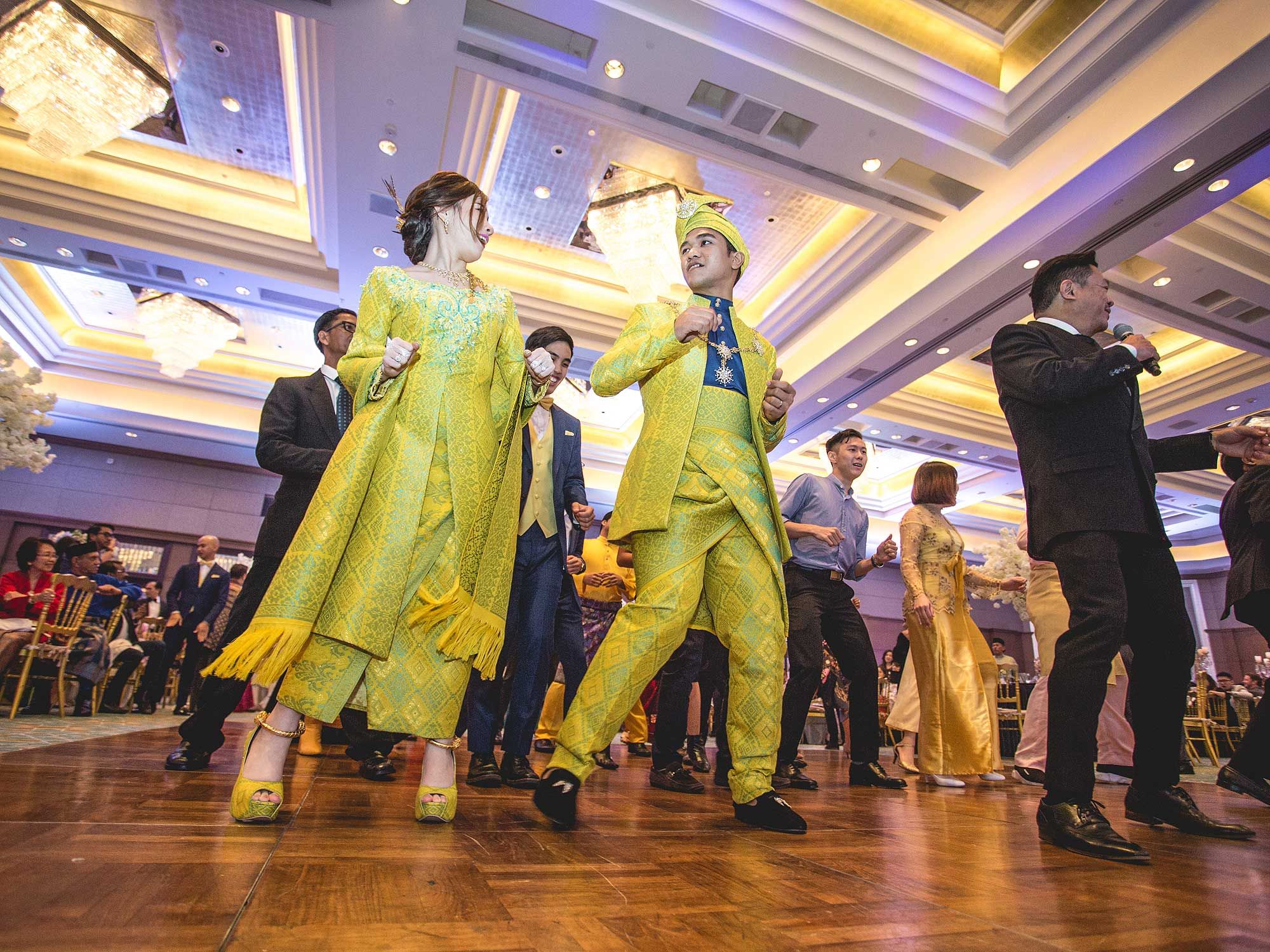 The couple trying to learn a Malay-style dance.