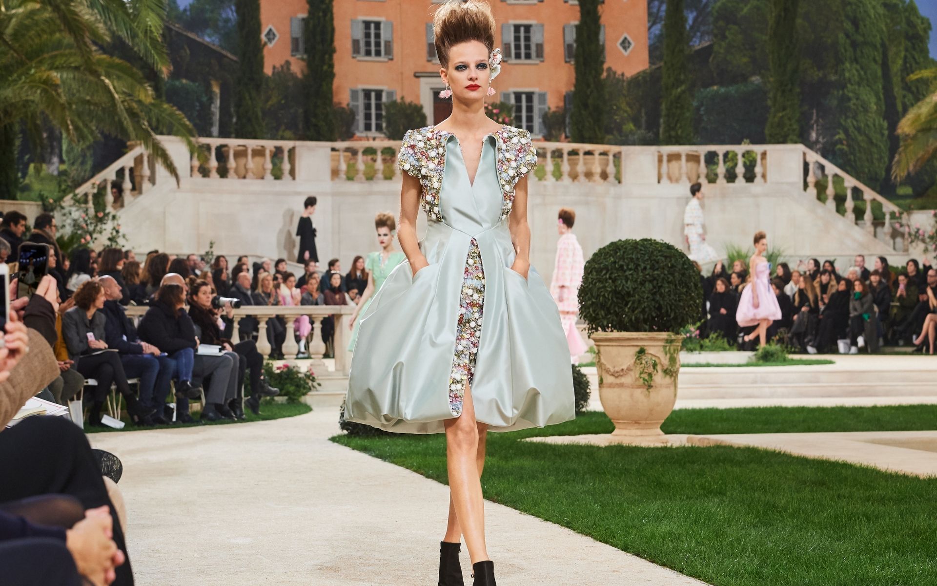 The collars of dresses turned inside out mimic boleros to reinvent the little black jacket (Photo credit: Chanel)