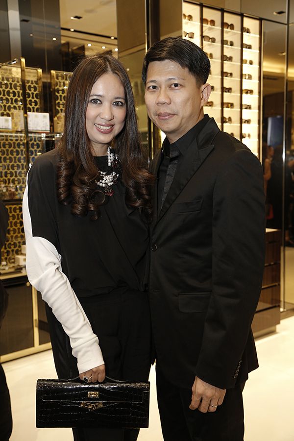 2014, February: Datin Yvette and her husband play matchy black outfits; hers with edgy white colour blocks, at a Gucci Artisan corner party