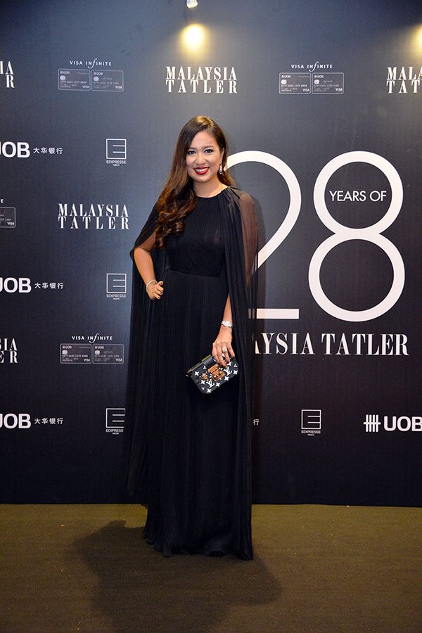 2017, November: Datin Yvette commanding a fashionable entrance in a robed Oscar de la Renta floor-length gown and Louis Vuitton petite malle clutch, at the Tatler Ball 2017