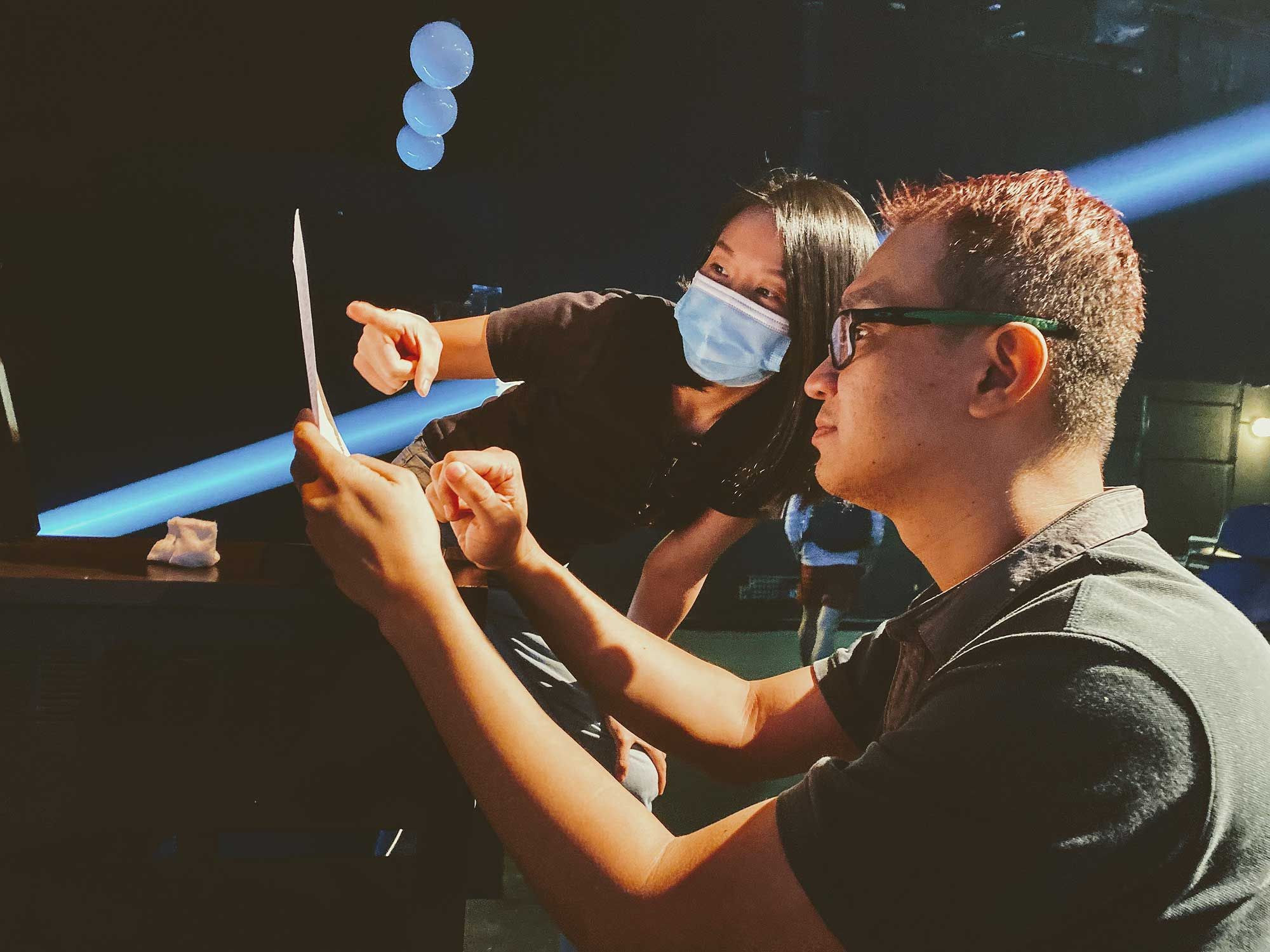 From left: music director Jing Xiuan and director Ian Chow preparing behind the scenes