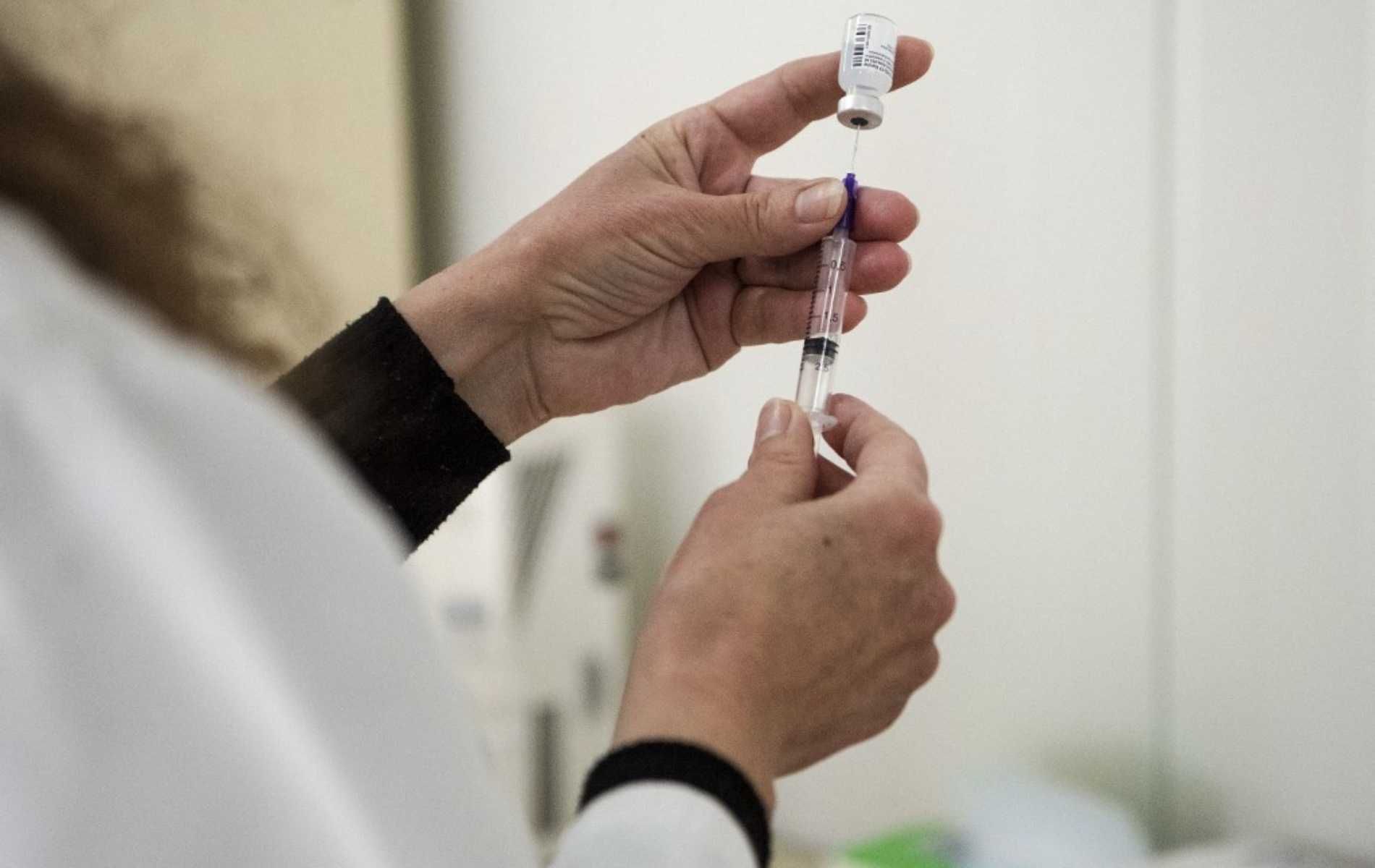 A medical worker fills a syringe with a dose of the Pfizer-BioNTech Covid-19 vaccine as the country launches its inoculation campaign at the University Clinic for Infectious Diseases in Skopje on February 17, 2021. - North Macedonia started with giving coronavirus vaccinations on February 17, 2021. A first batch consisting of 4,680 Pfizer vaccines donated by Serbia arrived during the weekend. (Photo by Robert ATANASOVSKI / AFP)