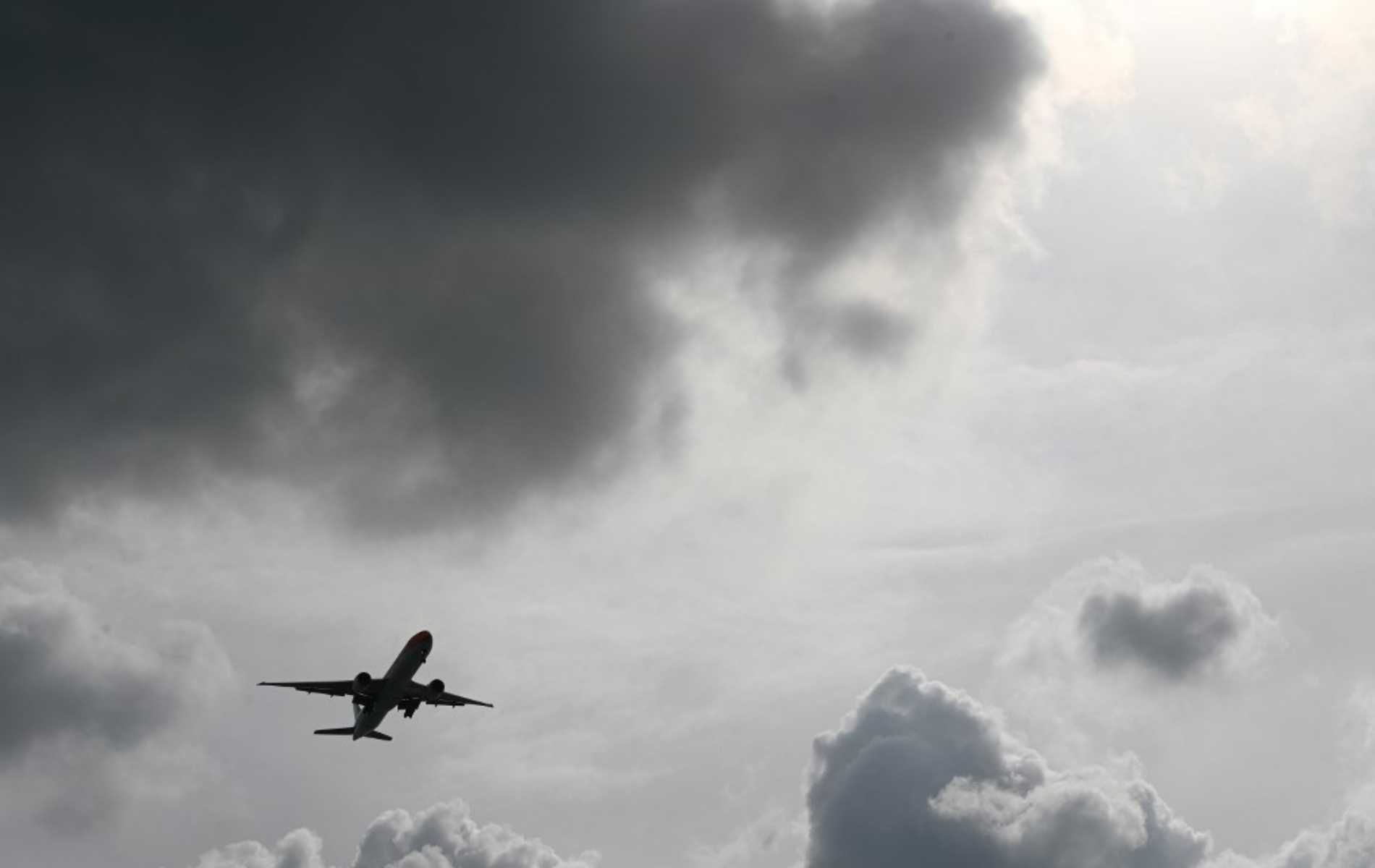 A passenger plane approaches for landing at Changi International Airport in Singapore on December 19, 2020. (Photo by Roslan RAHMAN / AFP)