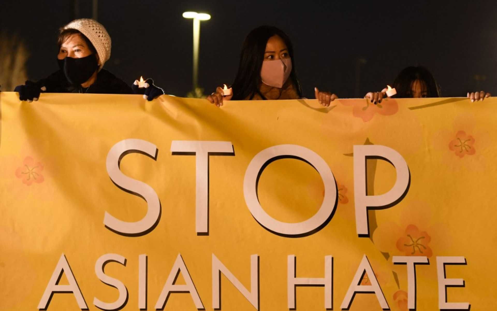 People hold lights during a vigil organized by Nailing It For America for those who have died from Covid-19 and to "Stop Asian Hate" on March 4, 2021 in Fountain Valley, California. - Orange County community volunteers formed the message of "Stop Asian Hate" with luminaries as reports of hate crimes against Asian Americans have increased since the beginning of the Covid-19 pandemic. (Photo by Patrick T. FALLON / AFP)