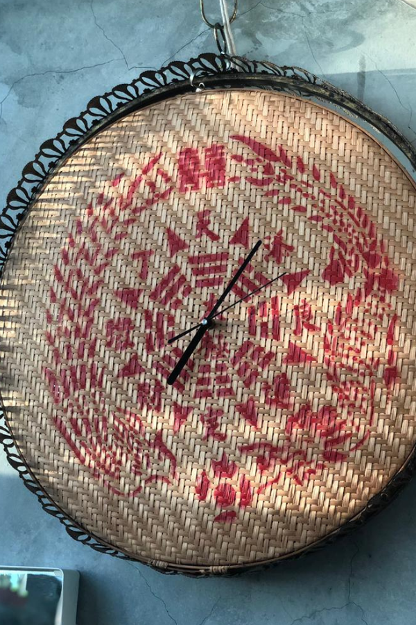 A woven rattan tray is repurposed as a clock