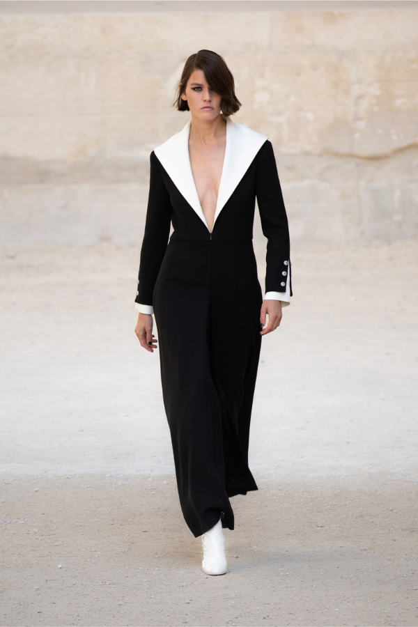The exaggerated white lapel and spliced cuff detailing makes for clean, minimalistic lines
