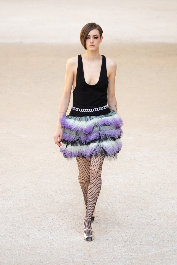 The soft-coloured rough fringing brings a feminine element to an otherwise low-cut, punk-inspired minidress