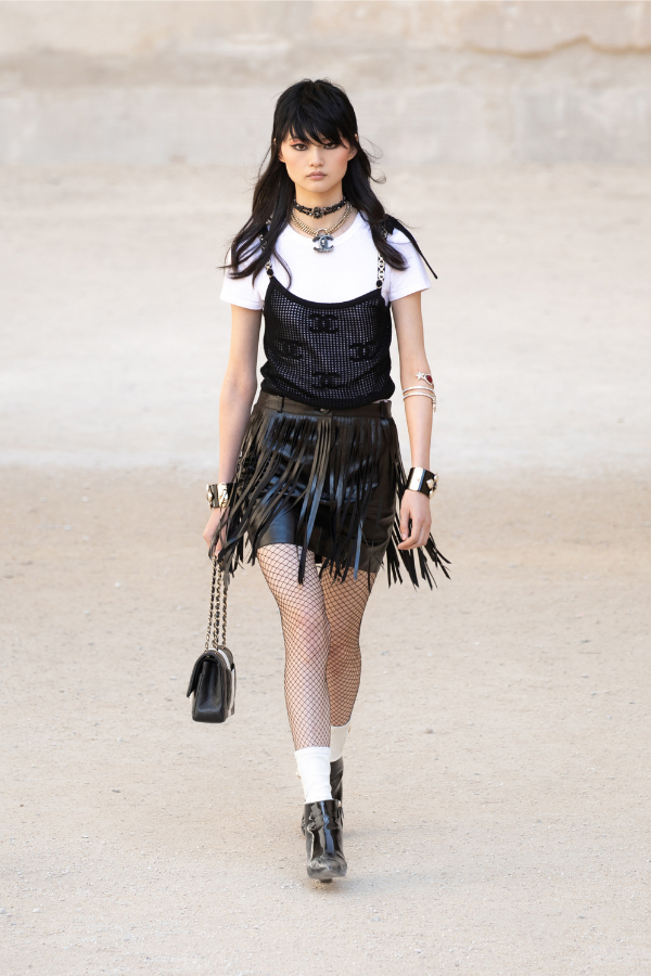 Punk-inspired details appear throughout the collection, from leather fringe and fishnets to metal cuffs and chain chokers