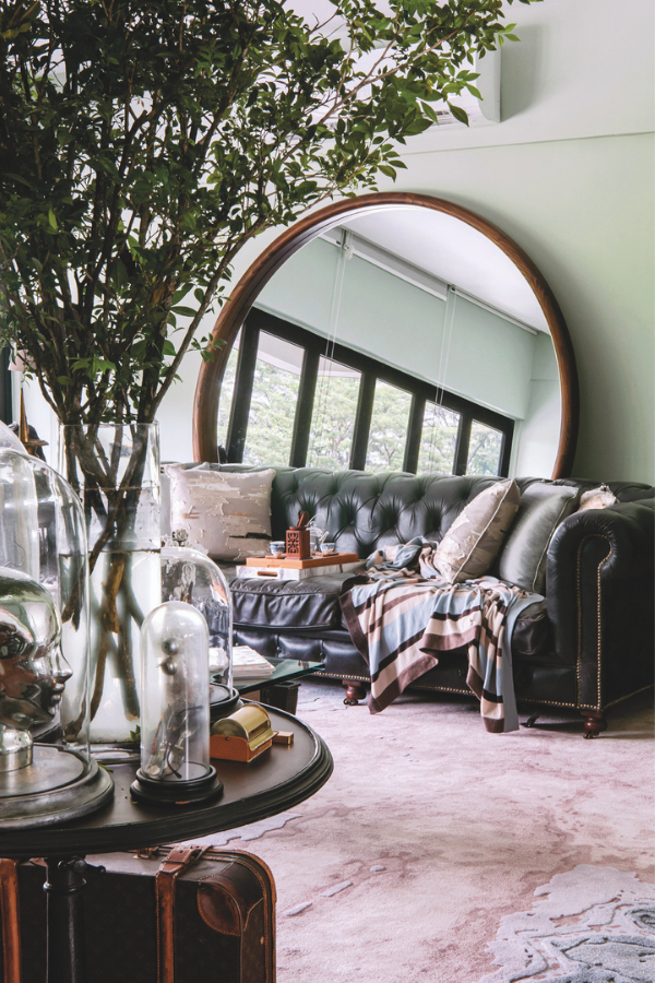 Khan is delighted by The Shire vibes the oversized round mirror imparts the living room (Photo: David Yeow Photography)