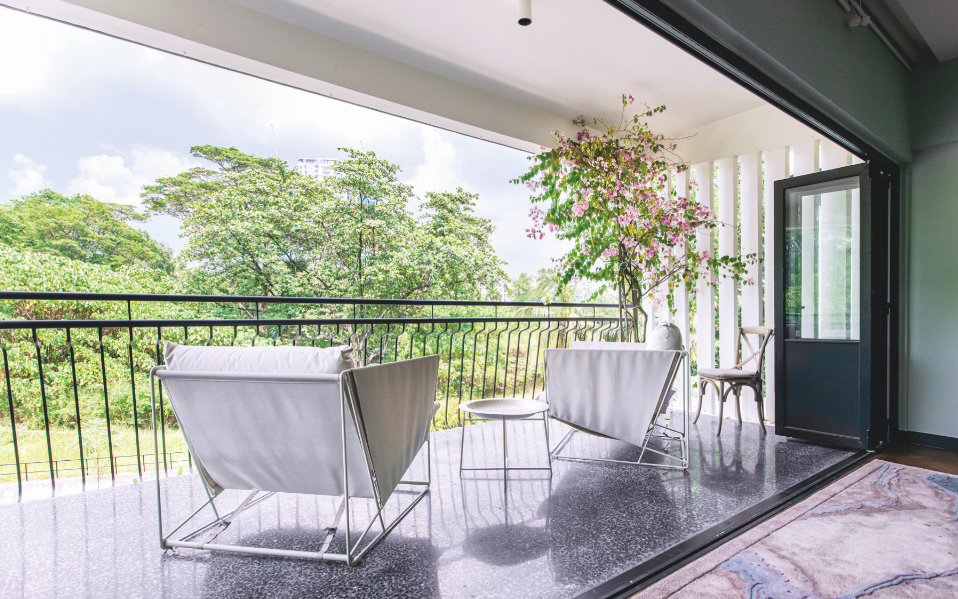 The development overlooks a forest reserve and Khan’s large balcony, complete with bougainvillea tree, is a fantastic place to enjoy it (Photo: David Yeow Photography)