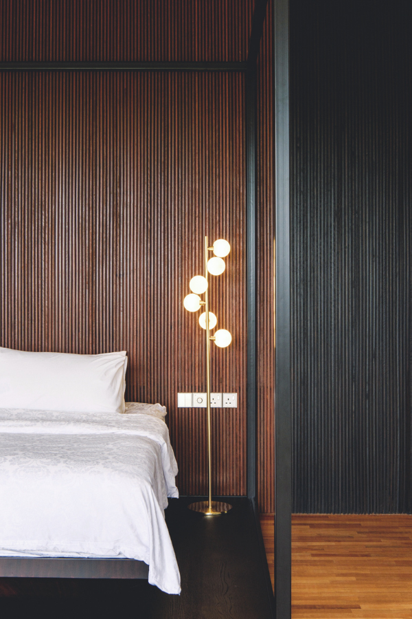 Finely detailed timber cladding forms the headboard