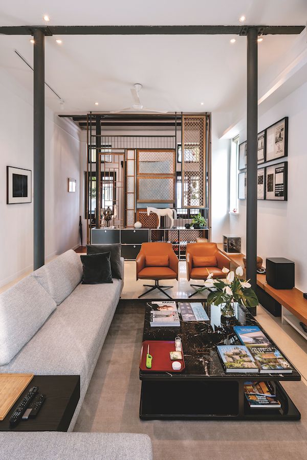 A screen separates the entrance foyer from the living room