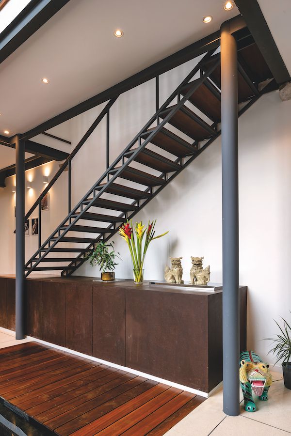The staircase and cabinet beneath it are precisely proportioned