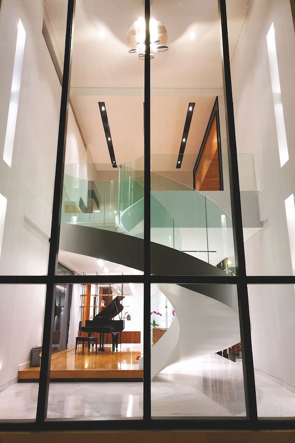 The sweeping spiral staircase in Jonathan's house is functional and sculptural