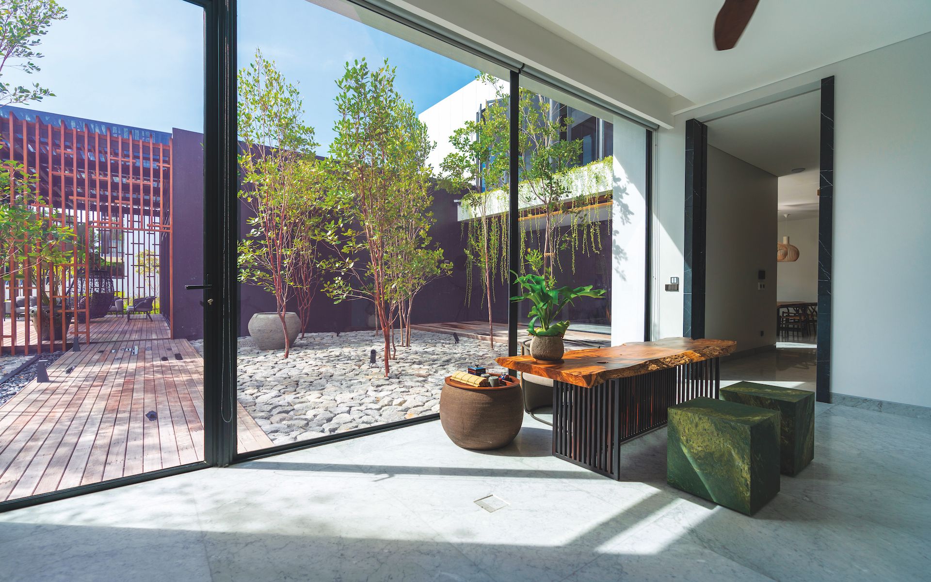 Large picture windows showcase the landscaped garden just outside as seen from Teresa's house