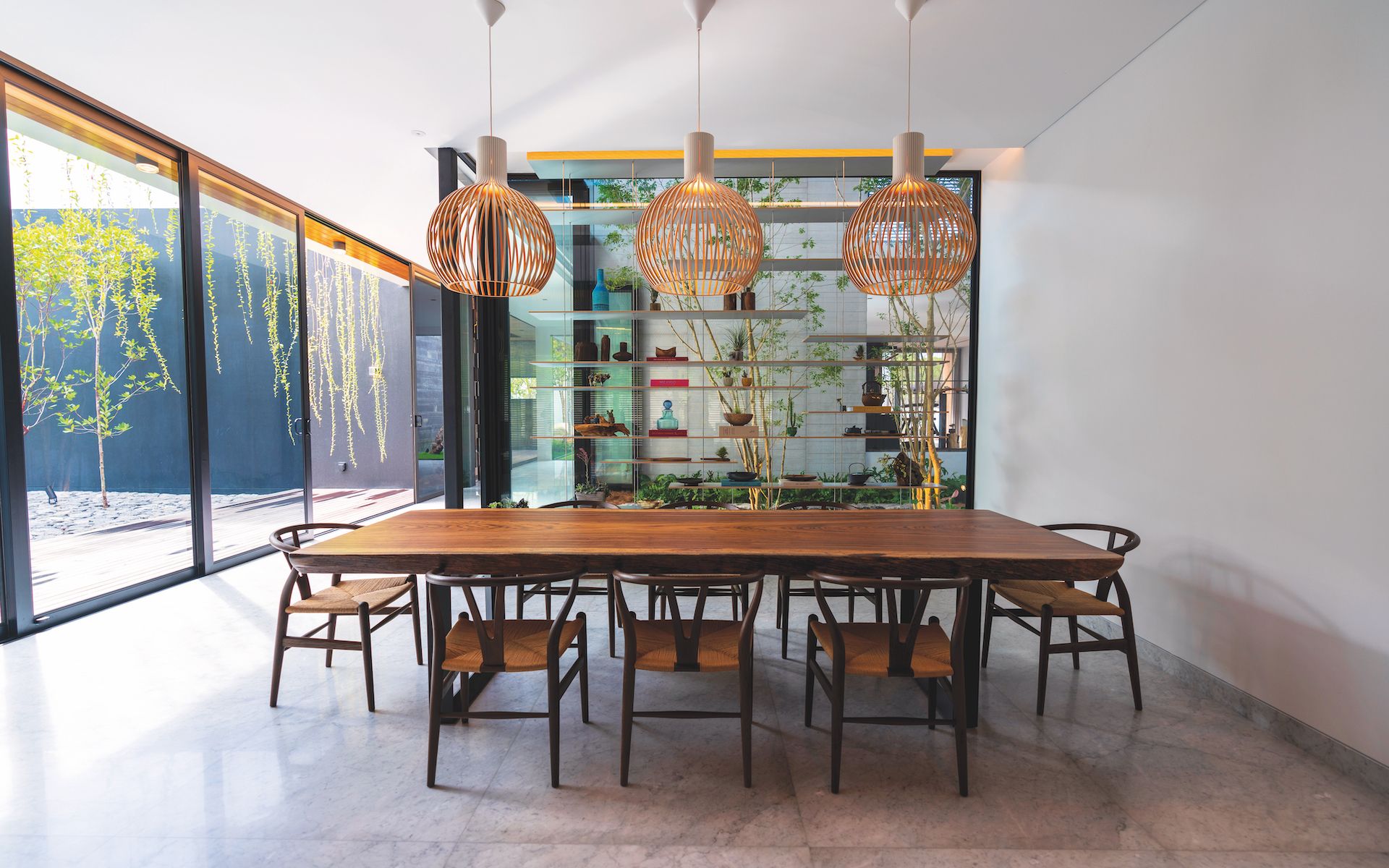 Sleek wooden furniture and lampshades in Teresa's dining room are rustic but modern
