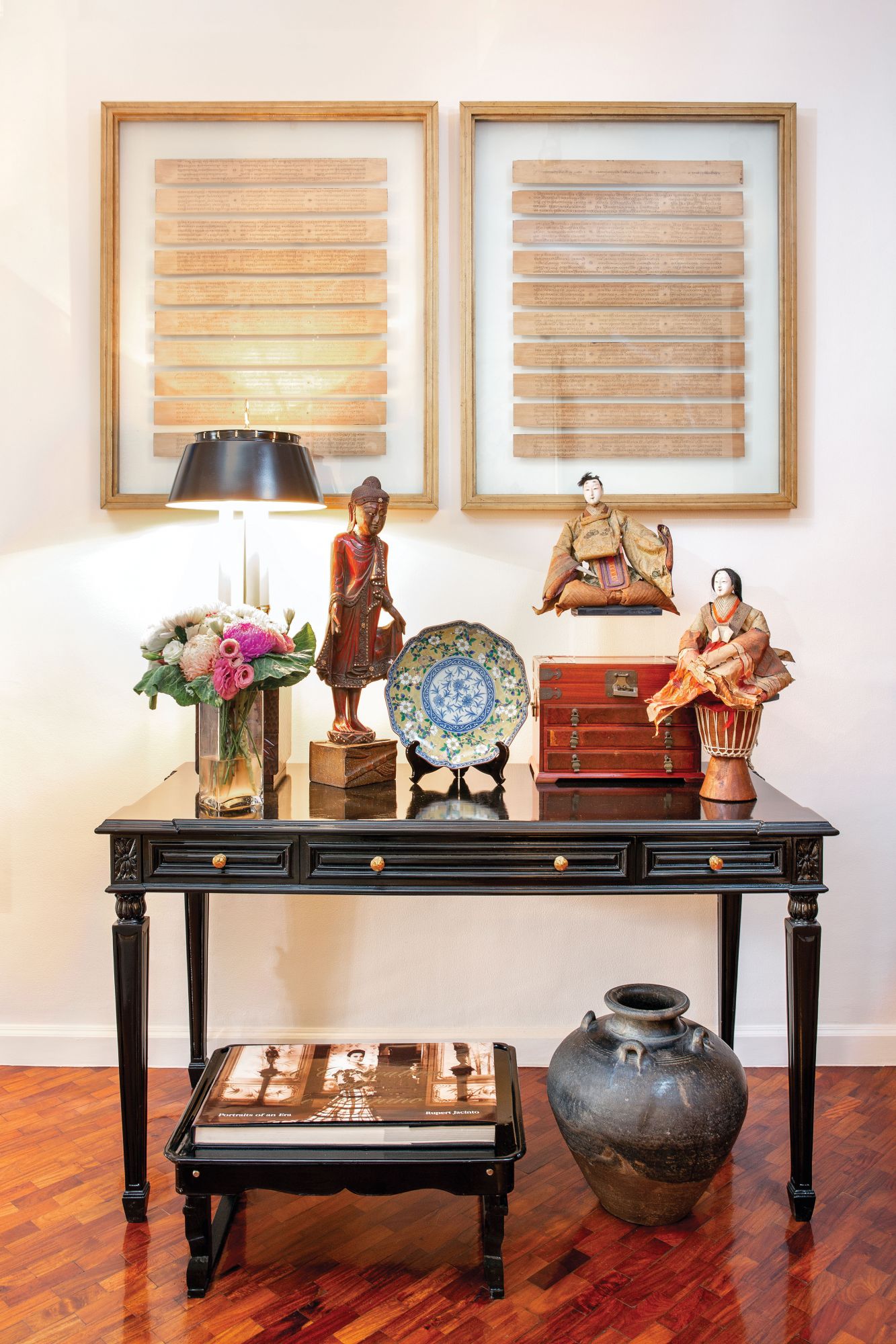 Antiquities from different nations share space on a console table
