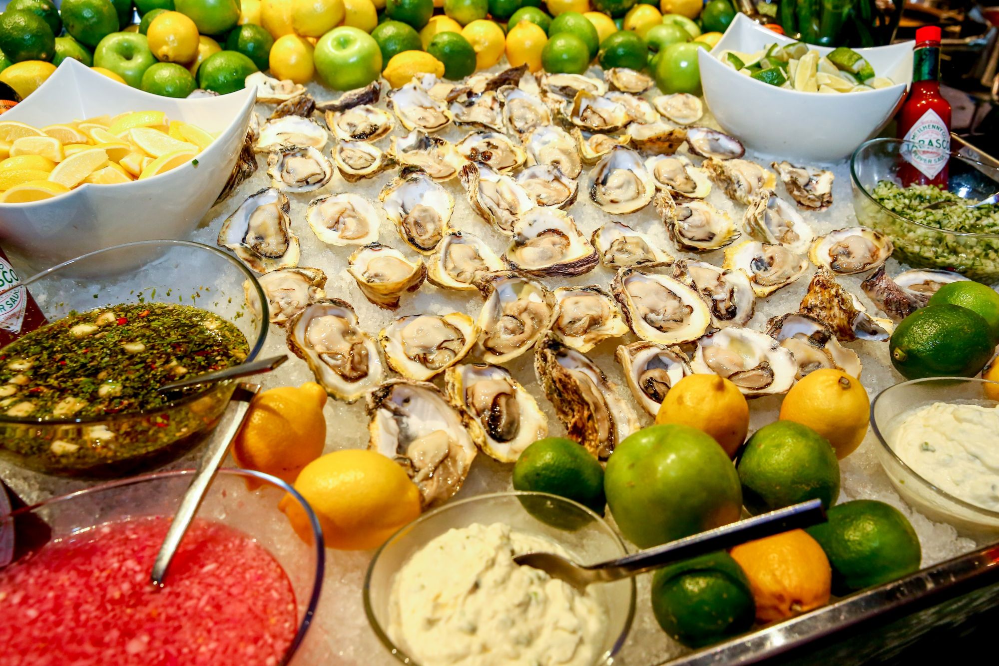 Various hors d'oeuvres such as oysters, shrimp, and tuna were served using sustainable seafood.