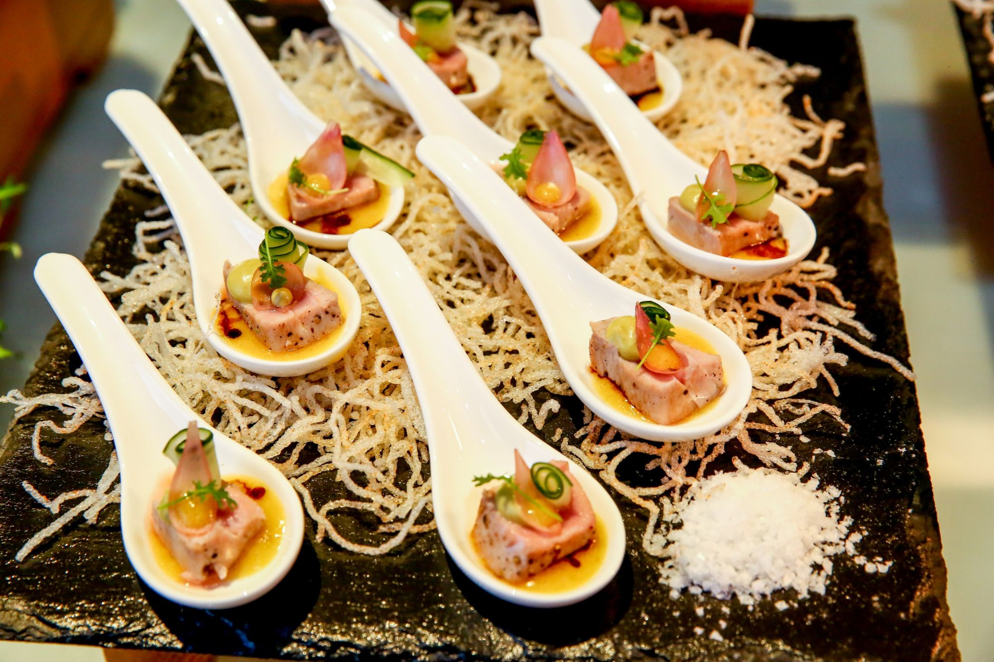 Various hors d'oeuvres such as oysters, shrimp, and tuna were served using sustainable seafood.